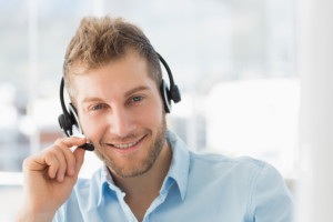 Smiling call centre agent wearing a headset